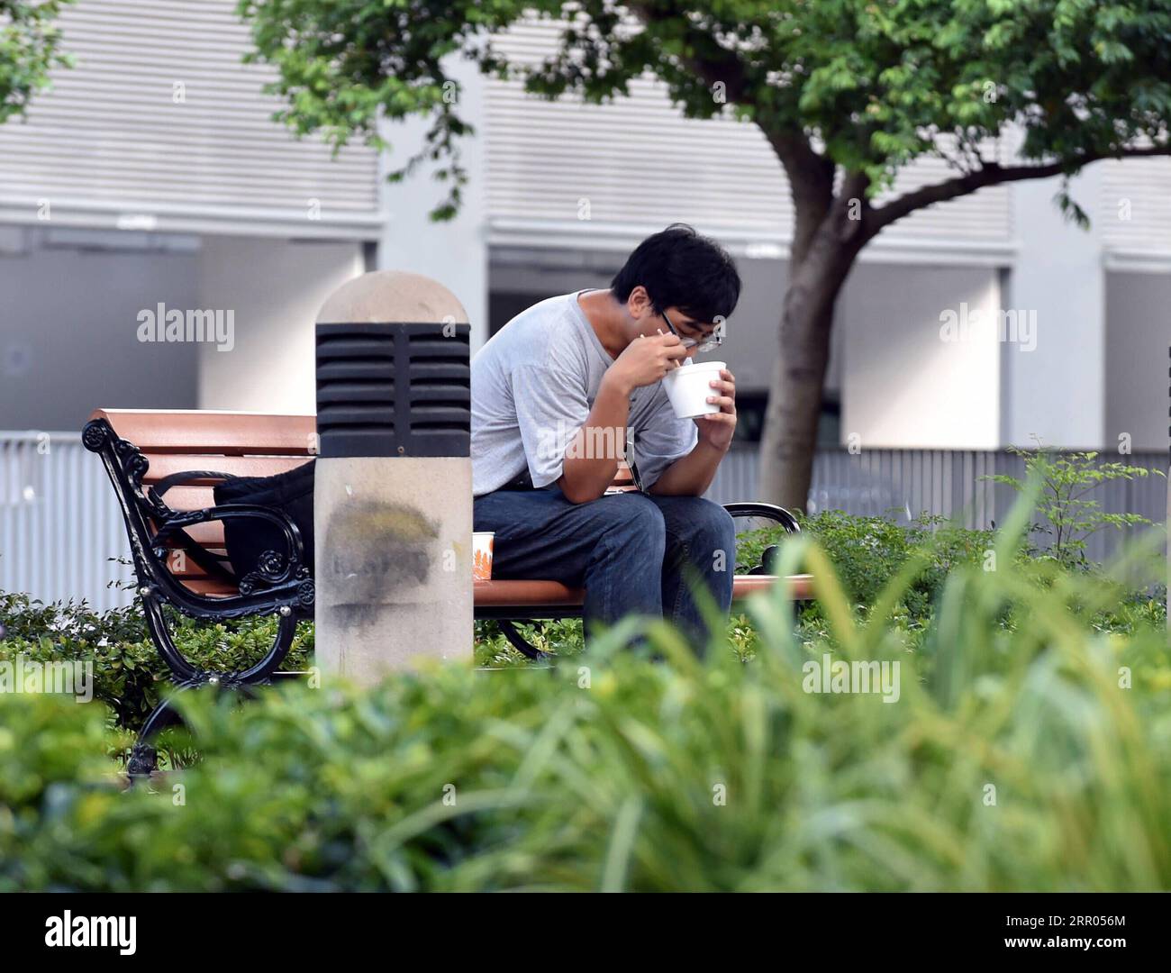 200729 -- HONG KONG, 29 luglio 2020 Xinhua -- Un uomo ha un pasto in un parco a Hong Kong, nel sud della Cina, 29 luglio 2020. Mercoledì a Hong Kong sono entrate in vigore misure più severe di distanziamento sociale. I servizi di ristorazione nei ristoranti sono vietati. Xinhua/lo Ping fai CHINA-HONG KONG-COVID-19-MISURE DI DISTANZIAMENTO SOCIALE CN PUBLICATIONxNOTxINxCHN Foto Stock