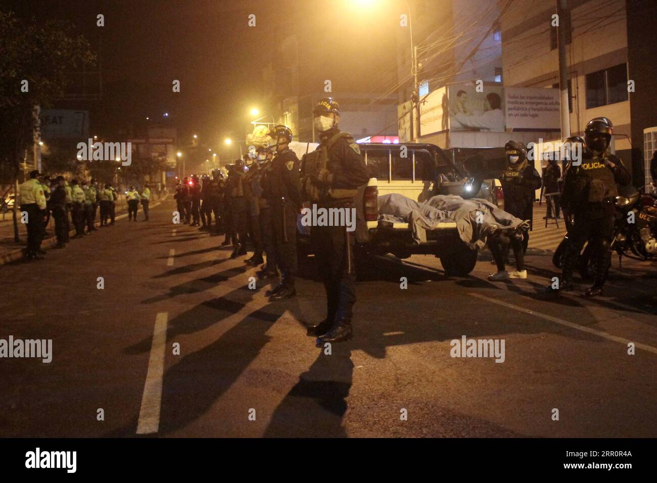 200824 -- LIMA, 24 agosto 2020 -- gli agenti di polizia stanno di guardia fuori dal nightclub dove è avvenuta la fuga a Lima, in Perù, 23 agosto 2020. Un raid della polizia di un nightclub nella capitale del Perù Lima ha lasciato almeno 13 morti e altri sei feriti mentre i clienti in preda al panico fuggivano verso l'uscita, hanno detto le autorità domenica. Secondo una dichiarazione del Ministero dell'interno, circa 120 persone sono state riunite per una festa all'interno del Thomas Restobar nel distretto di Los Olivos, nonostante l'attuale divieto di riunioni sociali a causa della nuova pandemia di COVID-19. Str/Xinhua PERÙ-LIMA-NIGHT CLUB-sta Foto Stock