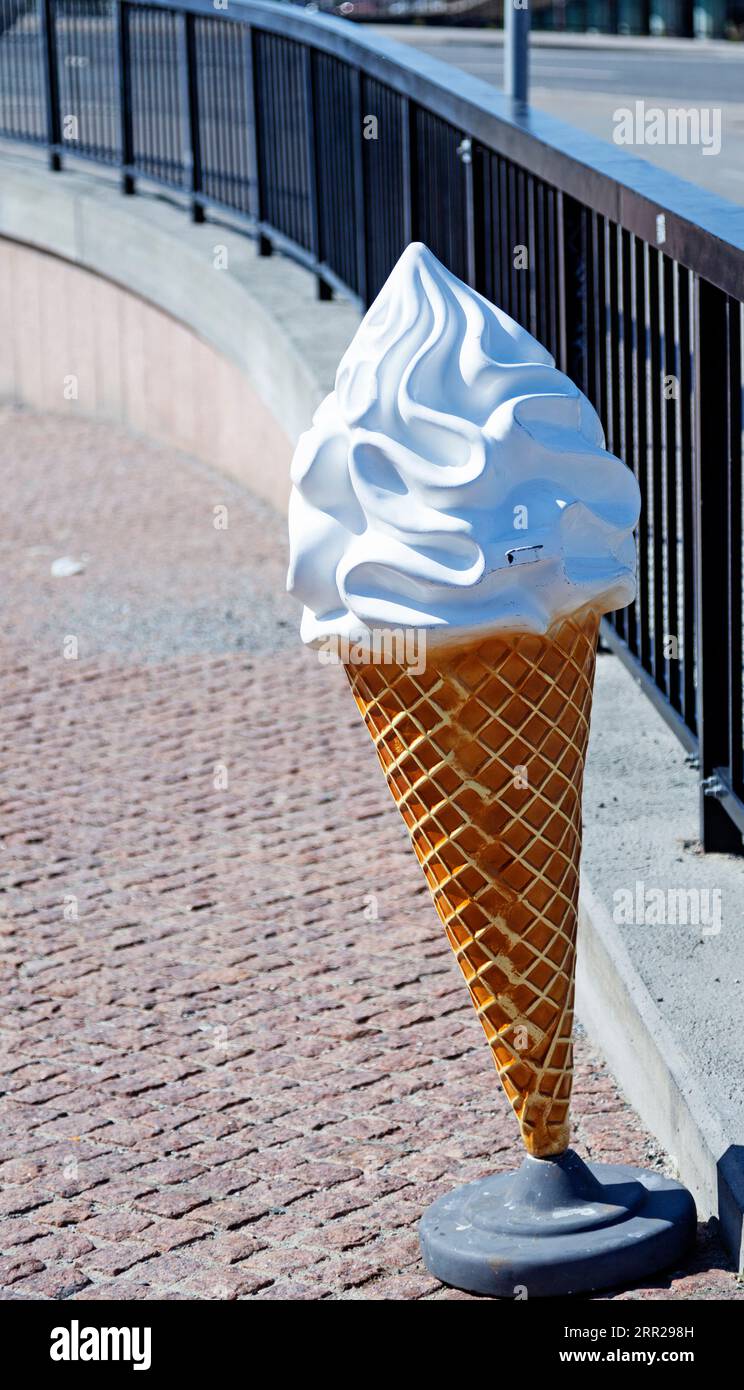 un enorme gelato morbido di plastica con cono come pubblicità sulla strada Foto Stock