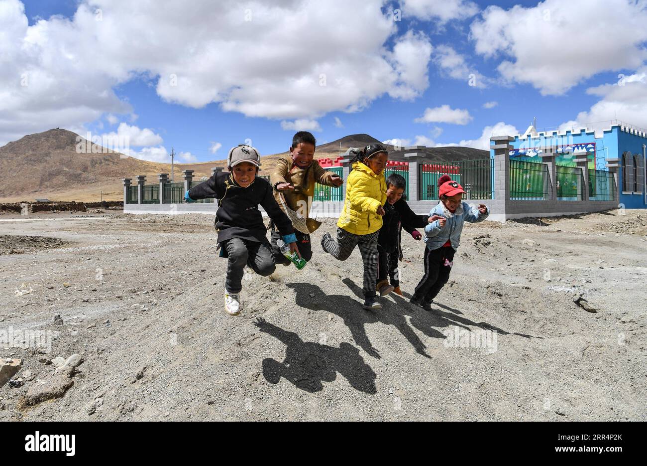 201210 -- LHASA, 10 dicembre 2020 -- i bambini giocano nei pressi di un asilo nido di nuova costruzione nella municipalità di Pumaqangtang della contea di Nagarze nello Shannan, nella regione autonoma del Tibet del sud-ovest della Cina, 16 aprile 2020. Pumaqangtang, la città più alta della Cina, ha un'altitudine media di 5.373 metri, con livelli di ossigeno inferiori al 40% a livello del mare. Gli abitanti del villaggio vivevano in case di roccia senza elettricità, acqua corrente, verdura o frutta disponibili. Tali condizioni di vita duri continuarono fino agli anni '1970 Al giorno d'oggi, tutti gli abitanti del villaggio di Pumaqangtang si sono trasferiti in residenze migliori. Rispetto a Th Foto Stock