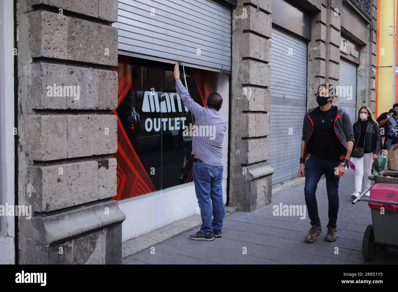 201219 -- CITTÀ DEL MESSICO, 19 dicembre 2020 -- Un uomo chiude la porta a scomparsa di un negozio a città del Messico, Messico, il 18 dicembre 2020. Venerdì le autorità messicane hanno detto che avrebbero reimposto le misure di confinamento a città del Messico e nello Stato del Messico tra i casi di COVID-19 in aumento e i ricoveri ospedalieri. Foto di /Xinhua MESSICO-CITTÀ DEL MESSICO-COVID-19 SunnyxQuintero PUBLICATIONxNOTxINxCHN Foto Stock