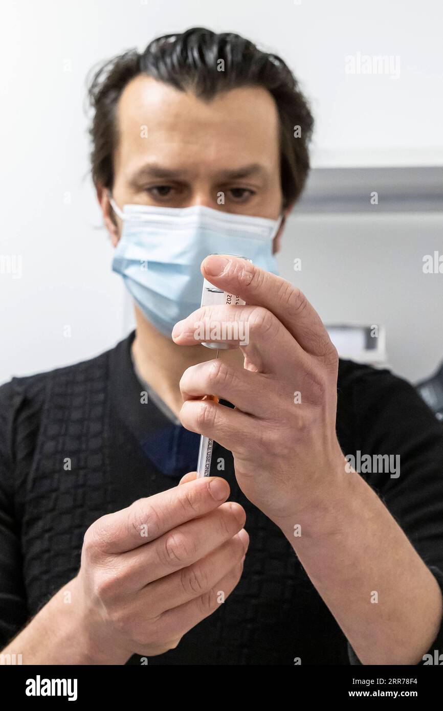 210319 -- TOURCOING FRANCIA, 19 marzo 2021 -- Un farmacista prepara una dose del vaccino COVID-19 AstraZeneca in una farmacia a Tourcoing, Hauts-de-France, Francia, il 19 marzo 2021. La Francia ha ripreso il lancio del vaccino AstraZeneca COVID-19 venerdì. La Francia è stato uno dei molti paesi europei che avevano sospeso l'introduzione del vaccino Oxford/AstraZeneca all'inizio di questa settimana, citando preoccupazioni per le segnalazioni di persone che sviluppano coaguli di sangue dopo il jab. Foto di /Xinhua FRANCE-TOURCOING-COVID-19 VACCINE-ASTRAZENECA-RESUMPTION SebastienxCourdji PUBLICATIONxNOTxINxCHN Foto Stock