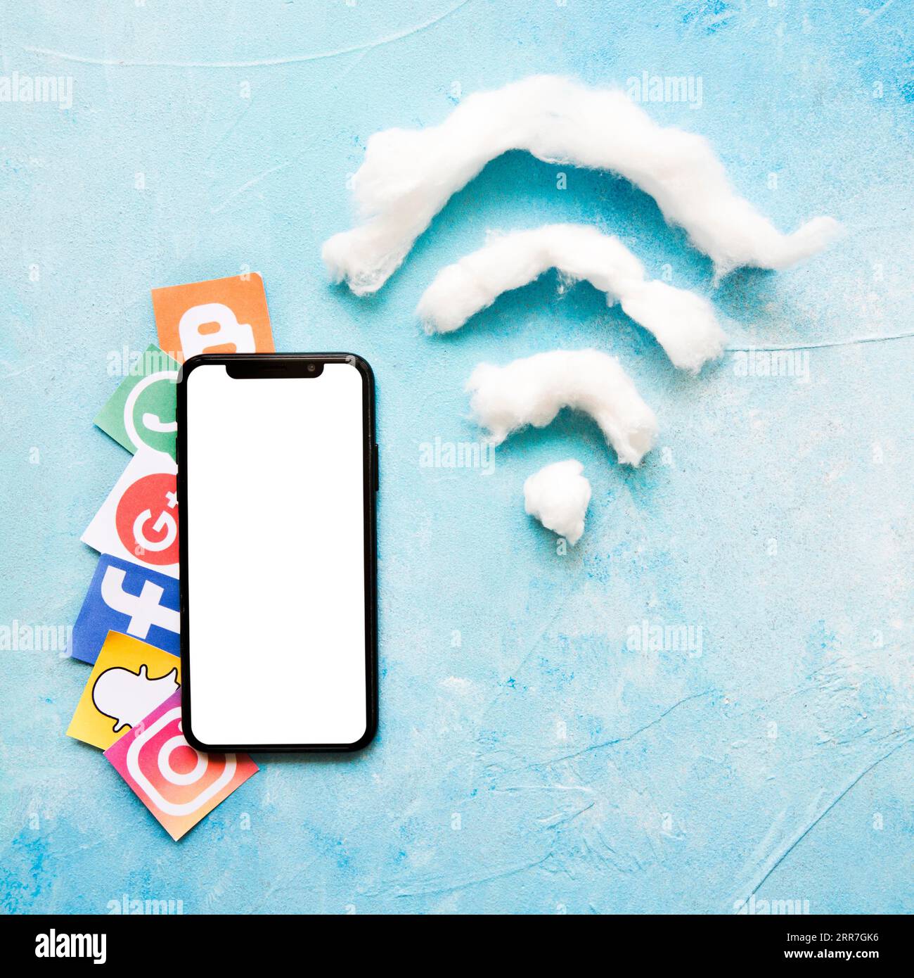 Icona vivida dei social media del telefono cellulare accanto al simbolo wi-fi in lana di cotone Foto Stock