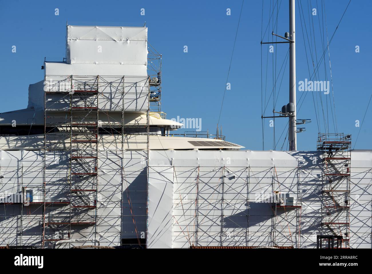 Yacht di lusso riadattati o sottoposti a manutenzione, coperti da impalcature e teloni, nel cantiere navale di la Ciotat o nei cantieri navali della Provenza Francia Foto Stock