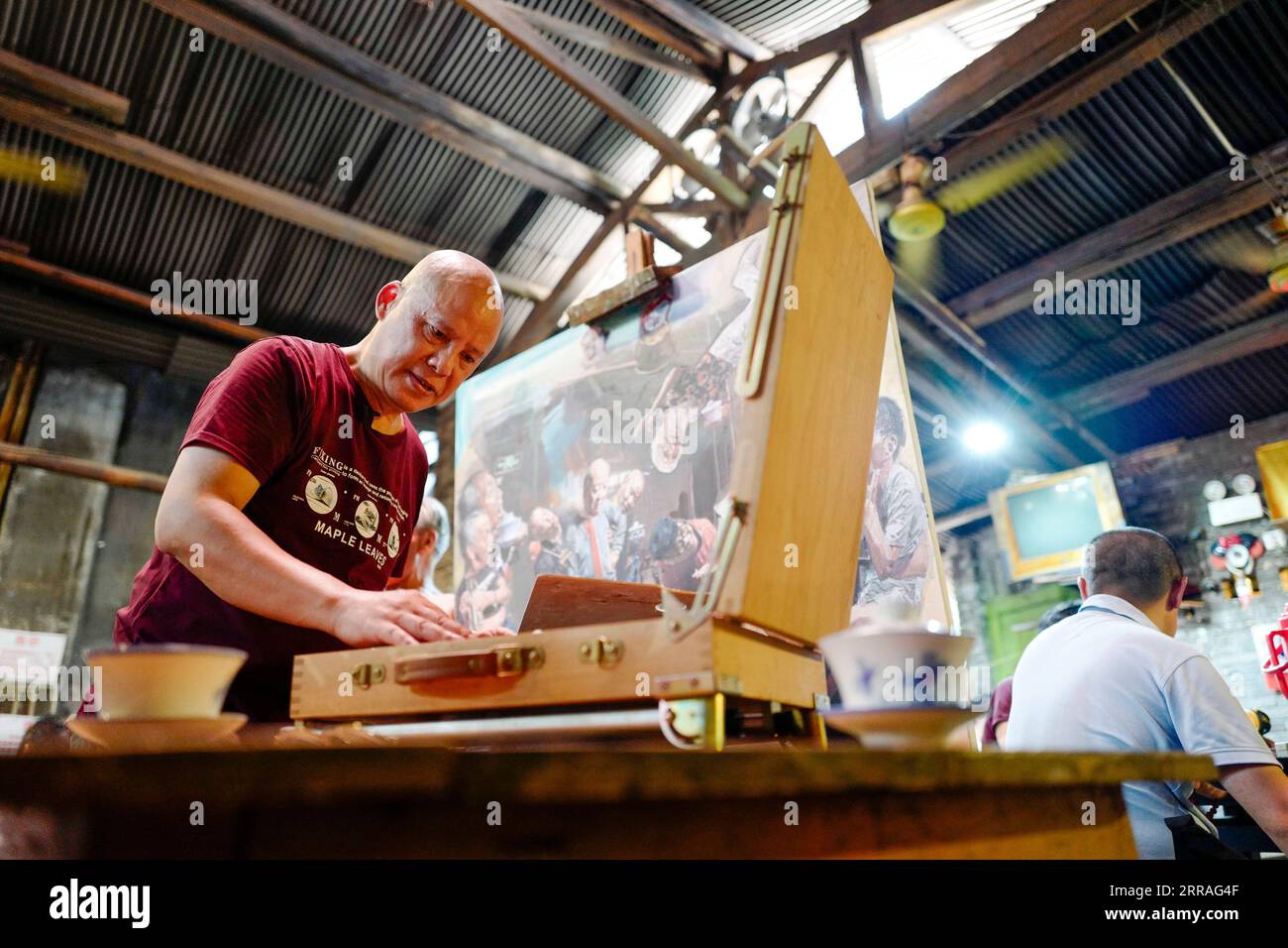 210730 -- CHONGQING, 30 luglio 2021 -- Chen Anjian L lavora su un dipinto ad olio alla Communications Teahouse nel sud-ovest della Cina a Chongqing, 26 luglio 2021. Chen Anjian, 62 anni, insegnante di pittura ad olio presso l'Istituto di Belle Arti di Sichuan, frequenta la Chongqing Communications Teahouse da più di 20 anni. Fondata nel 1987, la Communications Teahouse è ora l'unica vecchia casa da tè di Chongqing che ha mantenuto lo stile originale degli anni '1970 e '80 E' uno dei punti di riferimento culturali chiave di Chongqing, ed e' visitato da migliaia di amanti del te' ogni giorno. La Communications Teahouse è la spa vivente Foto Stock