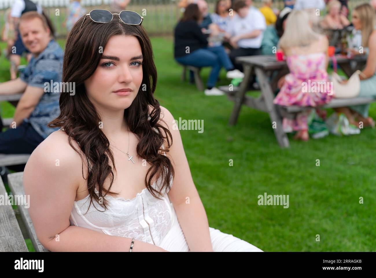 Ritratto sincero di una bella donna in abiti alla moda si gode il Ladies Day alle gare di Beverley, Regno Unito. Foto Stock