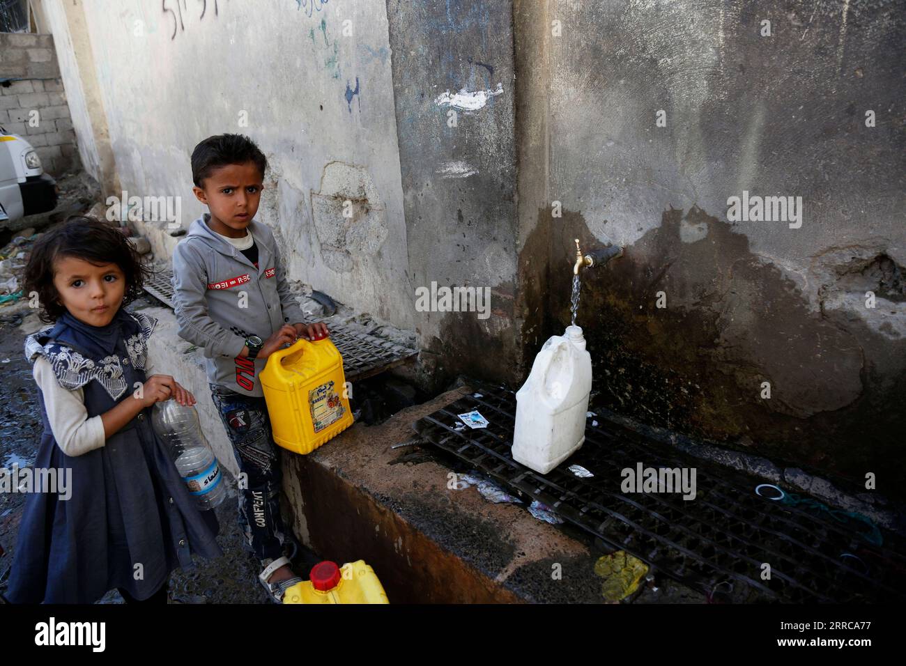 211028 -- SANAA, 28 ottobre 2021 -- i bambini yemeniti riempiono i contenitori di plastica con acqua in un sito di raccolta idrica di beneficenza a Sanaa, Yemen, il 28 ottobre 2021. Foto di /Xinhua YEMEN-SANAA-WATER-SHORTAGE MohammedxMohammed PUBLICATIONxNOTxINxCHN Foto Stock