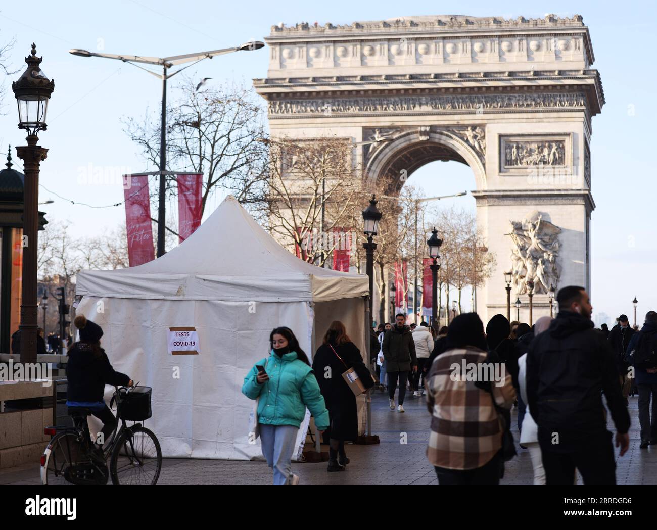 Coronavirus, Eindrücke aus Paris 211224 -- PARIGI, 24 dicembre 2021 -- la gente cammina vicino a una tenda di prova rapida COVID-19 vicino all'Arco di Trionfo a Parigi, Francia, 23 dicembre 2021. FRANCE-PARIS-COVID-19-DAILY LIFE GaoxJing PUBLICATIONxNOTxINxCHN Foto Stock