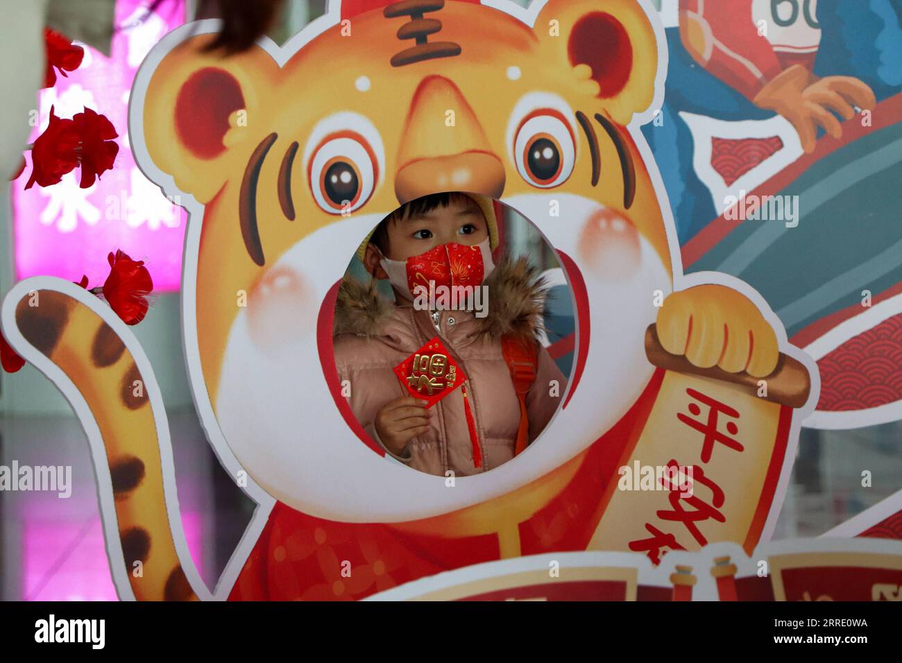 220117 -- HOHHOT, 17 gennaio 2022 -- Un bambino posa per una foto alla stazione ferroviaria di Hohhot East a Hohhot, nella regione autonoma della Mongolia interna della Cina settentrionale, 17 gennaio 2022. La stagione turistica del Festival di primavera 2022 della Cina dovrebbe vedere 1,18 miliardi di viaggi passeggeri, in aumento del 35,6% anno dopo anno, ma 20,3% in meno rispetto a quello del 2020, ha detto il Ministero dei trasporti. La stagione dei viaggi di 40 giorni, nota anche come chunyun, ha dato il via lunedì e molte persone si recheranno per riunirsi con le loro famiglie per il Capodanno lunare o il Festival di primavera, che cade il 1° febbraio di quest'anno. CHINA-SPRING FESTIVAL-TRAVEL Foto Stock