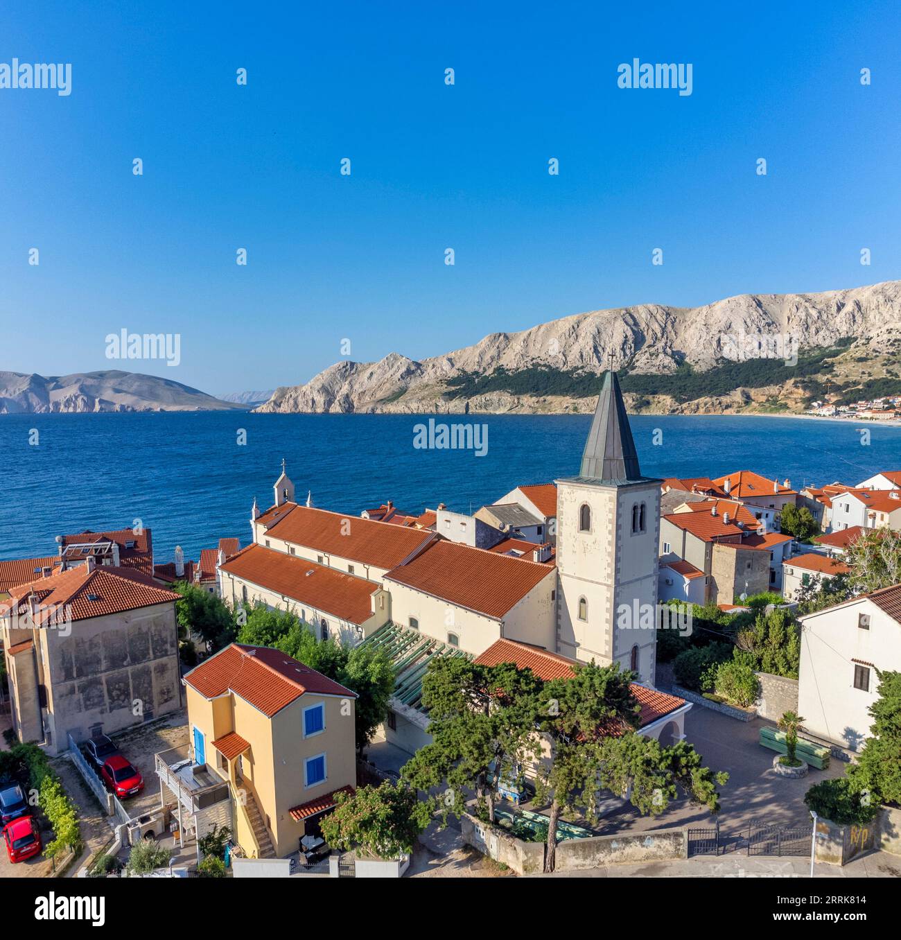 Croazia, baia del Quarnero, Primorje Gorski Kotar County, isola di Krk, vista sopraelevata di Baska con dettagli sulla chiesa della Santissima Trinità Foto Stock