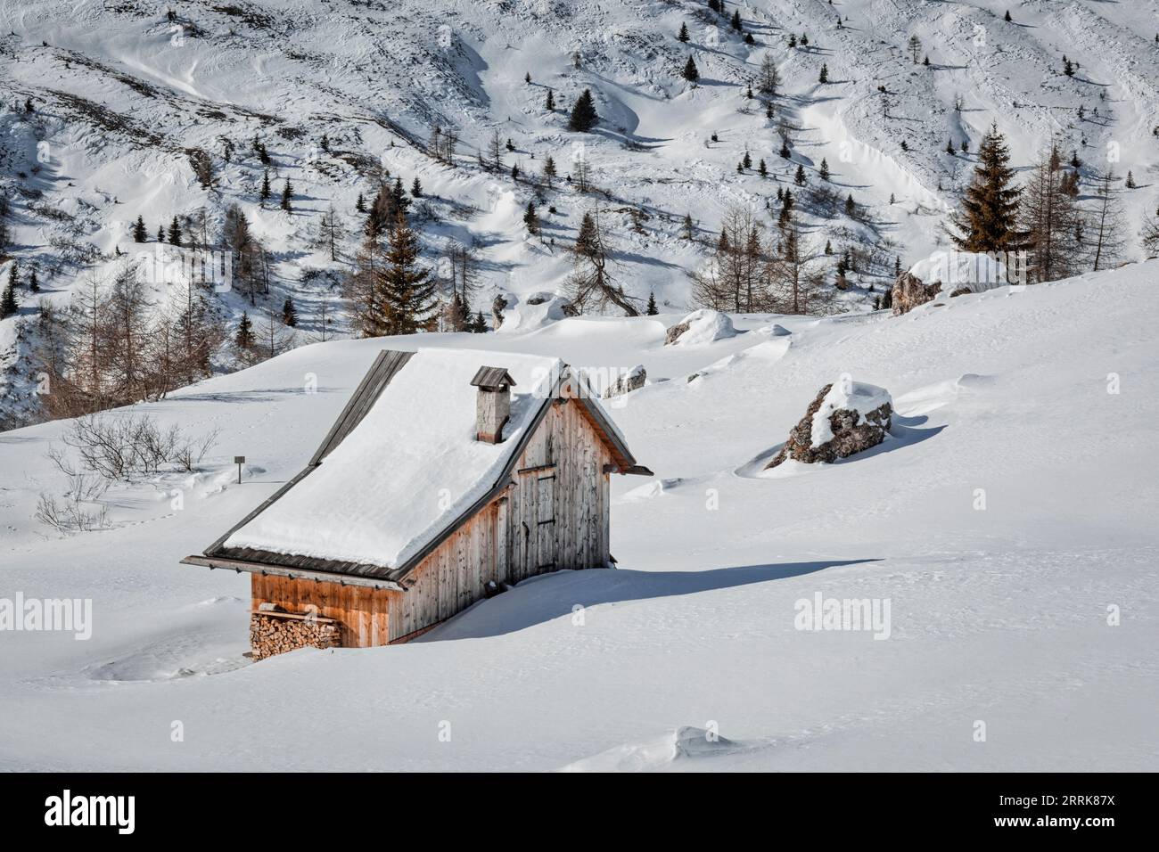 Italia, Veneto, Provincia di Belluno, Colle Santa Lucia, rifugio solitario con neve lungo la strada del passo del Giau Foto Stock