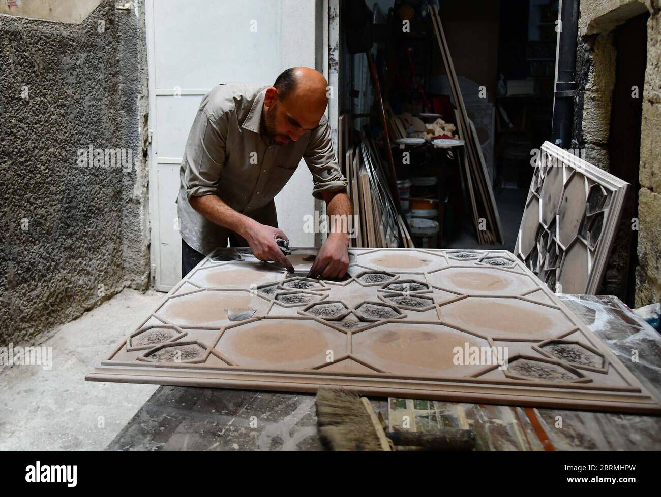 221101 -- DAMASCO, 1 novembre 2022 -- Un artigiano siriano applica una pasta viscosa a motivi pre-disegnati su una tavola per creare una decorazione siriana di pareti e soffitti nota come pittura di Damascene o Ajami in un laboratorio a Damasco, Siria, 31 ottobre 2022. Ajami è un artigianato tradizionale utilizzato per la decorazione interna di vecchie case in Siria foto di /Xinhua SIRIA-DAMASCO-DAMASCENE DIPINTO AmmarxSafarjalani PUBLICATIONxNOTxINxCHN Foto Stock