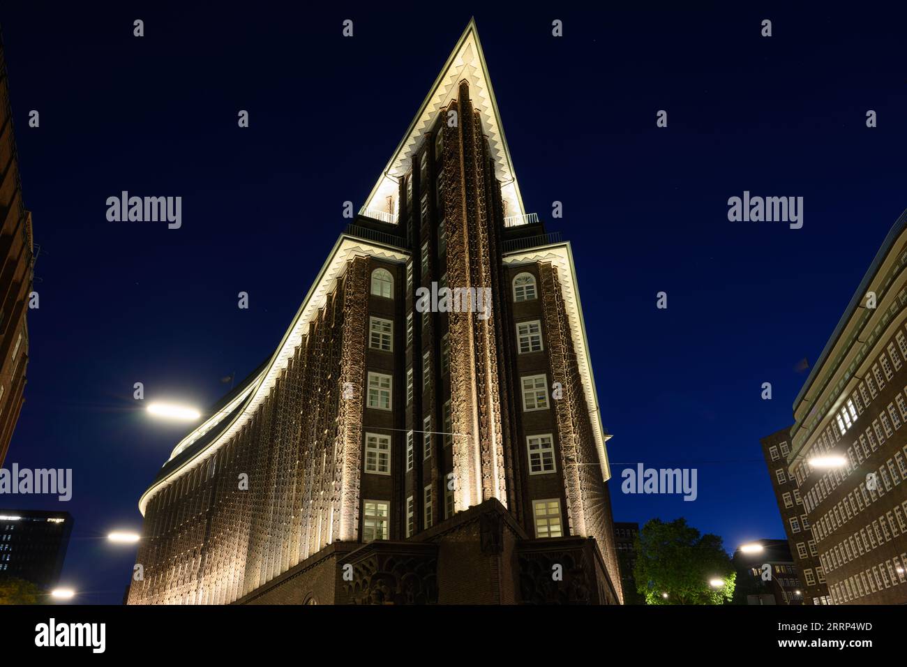 Amburgo, Germania - 15 giugno 2023: Chilehaus o Casa del Cile nel quartiere Kontorhaus illuminata di notte. Foto Stock