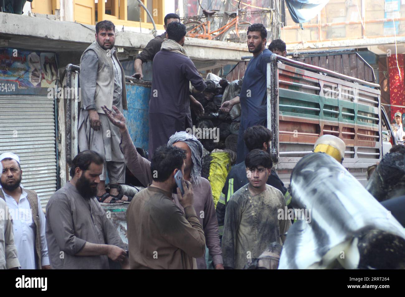 230624 -- JALALABAD, 24 giugno 2023 -- i negozianti afghani trasportano merci semi-bruciate dal sito di un incendio a Jalalabad, provincia di Nangarhar, Afghanistan, 21 giugno 2023. Proprietà e beni che valgono più di 1 milione di dollari sono stati bruciati in cenere quando un hotel ha preso fuoco nella città di Jalalabad, un funzionario del governo provinciale ha detto giovedì. Foto di /Xinhua AFGHANISTAN-NANGARHAR-JALALABAD-FIRE AimalxZahir PUBLICATIONxNOTxINxCHN Foto Stock