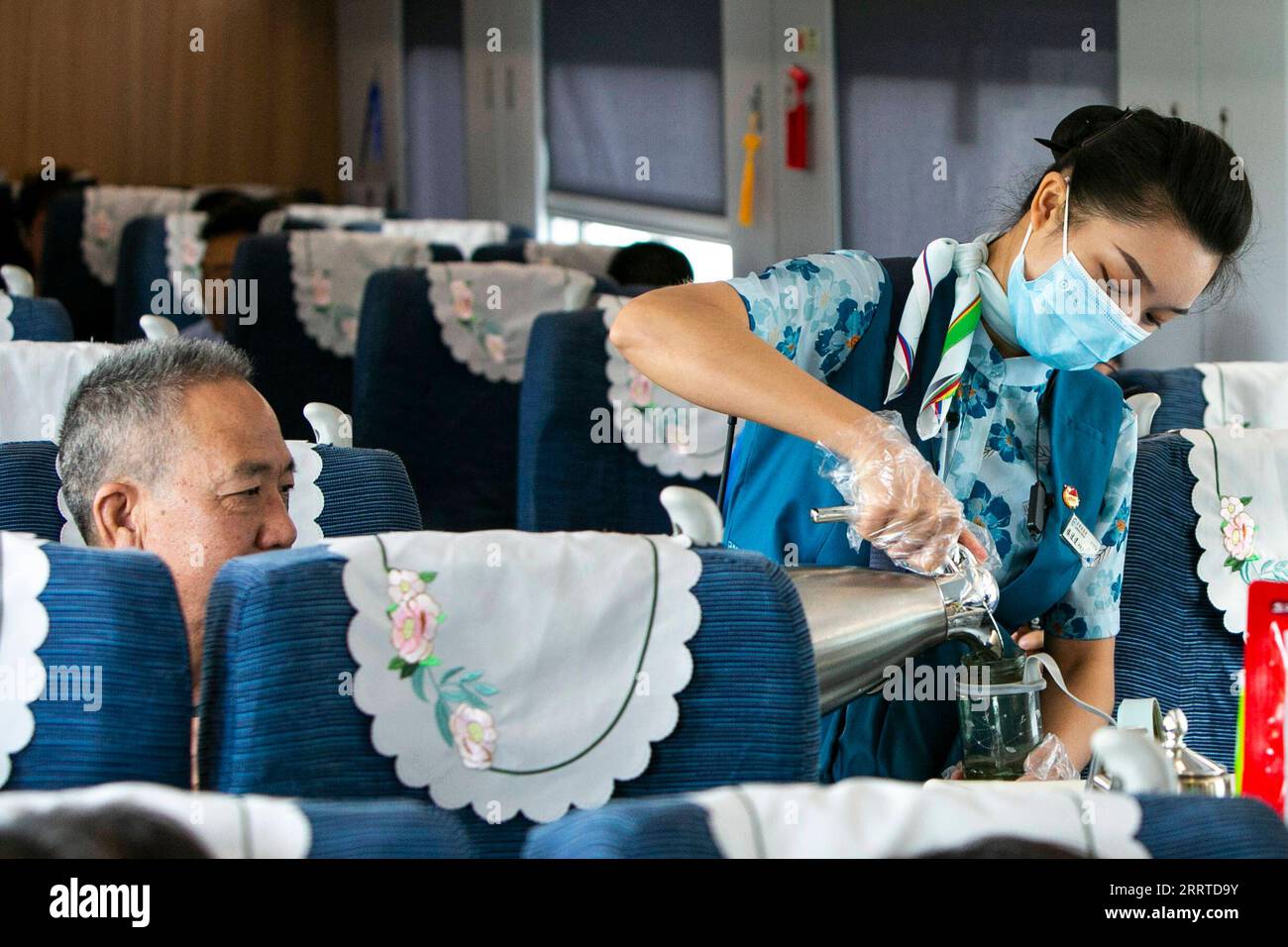 230718 -- MENGLA, 18 luglio 2023 -- Yi Bofeng R serve un passeggero a bordo del treno D887 il 16 luglio 2023. Yi Bofeng proviene dalla contea di Mengla, nella provincia dello Yunnan. Dopo essersi laureata come Lao Major in un college tecnico nella capitale provinciale Kunming nel 2020, è stata reclutata come assistente ferroviario sotto la China Railway Kunming Bureau Group Co., Ltd La China-Laos Railway, un importante progetto di cooperazione tra Belt e Road di alta qualità, ha iniziato le sue attività nel dicembre 2021. Yi era a bordo del primo treno della ferrovia, testimoniando il momento storico delle operazioni ferroviarie. 1.035 km di ferrovia Foto Stock