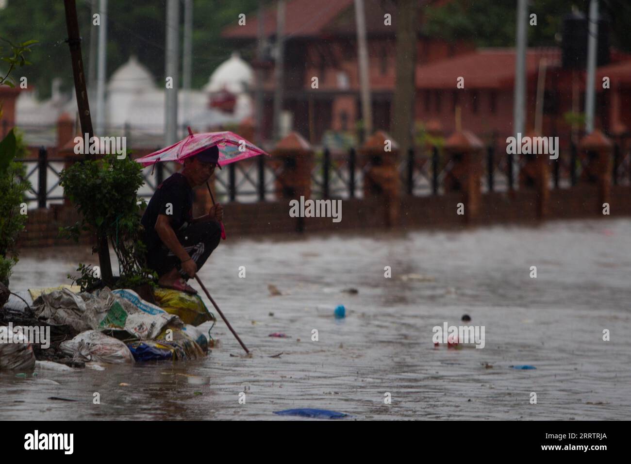 230808 -- KATHMANDU, 8 agosto 2023 -- Un uomo guarda le inondazioni d'acqua a Kathmandu, Nepal, l'8 agosto 2023. Le piogge monsoniche hanno causato inondazioni in varie parti di Kathmandu. Foto di /Xinhua NEPAL-KATHMANDU-FLOODS SulavxShrestha PUBLICATIONxNOTxINxCHN Foto Stock