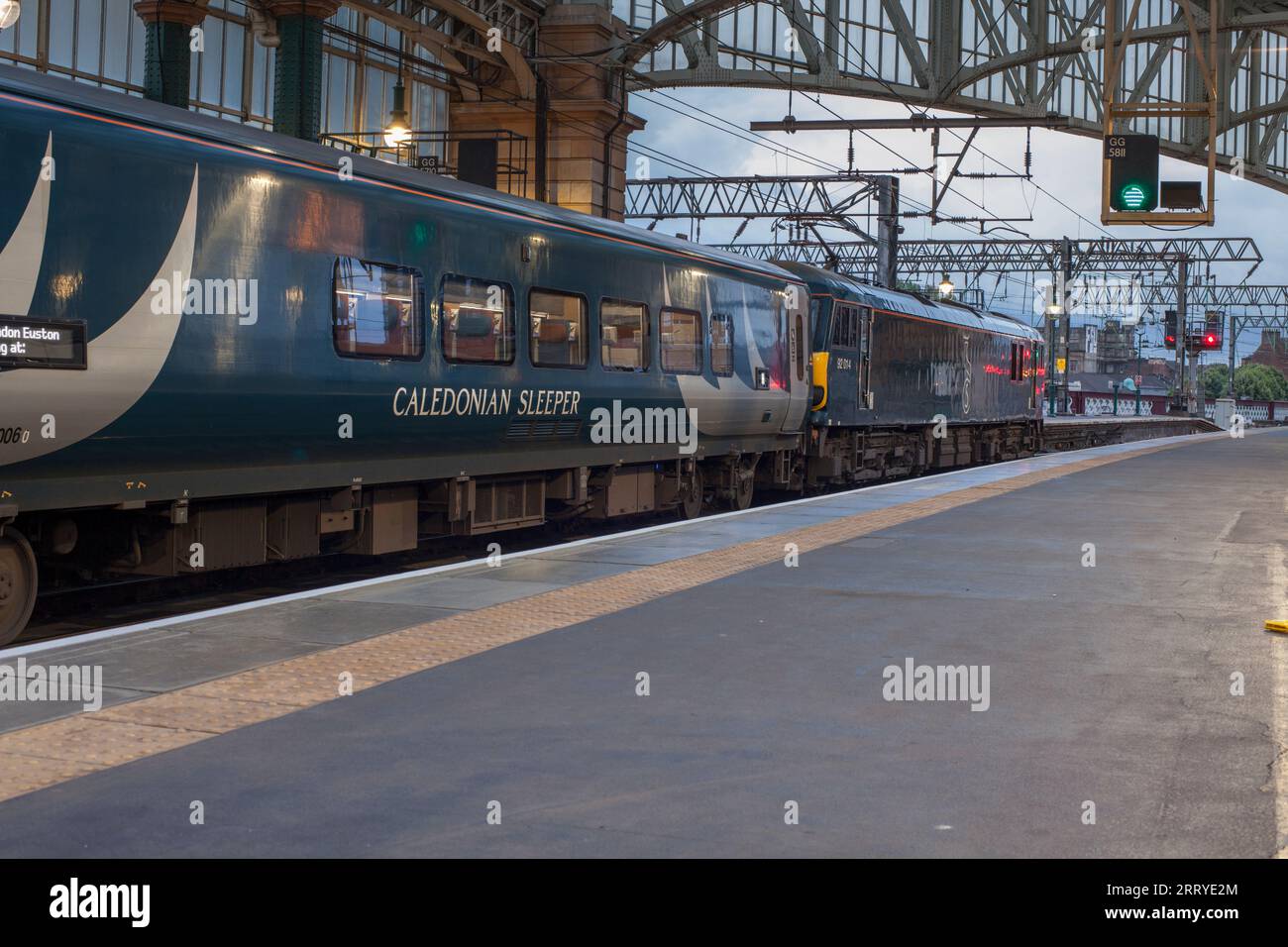 Il treno caledoniano a dorso di pianura in attesa di partire dalla stazione centrale di Glasgow con una locomotiva elettrica di classe 92 Foto Stock