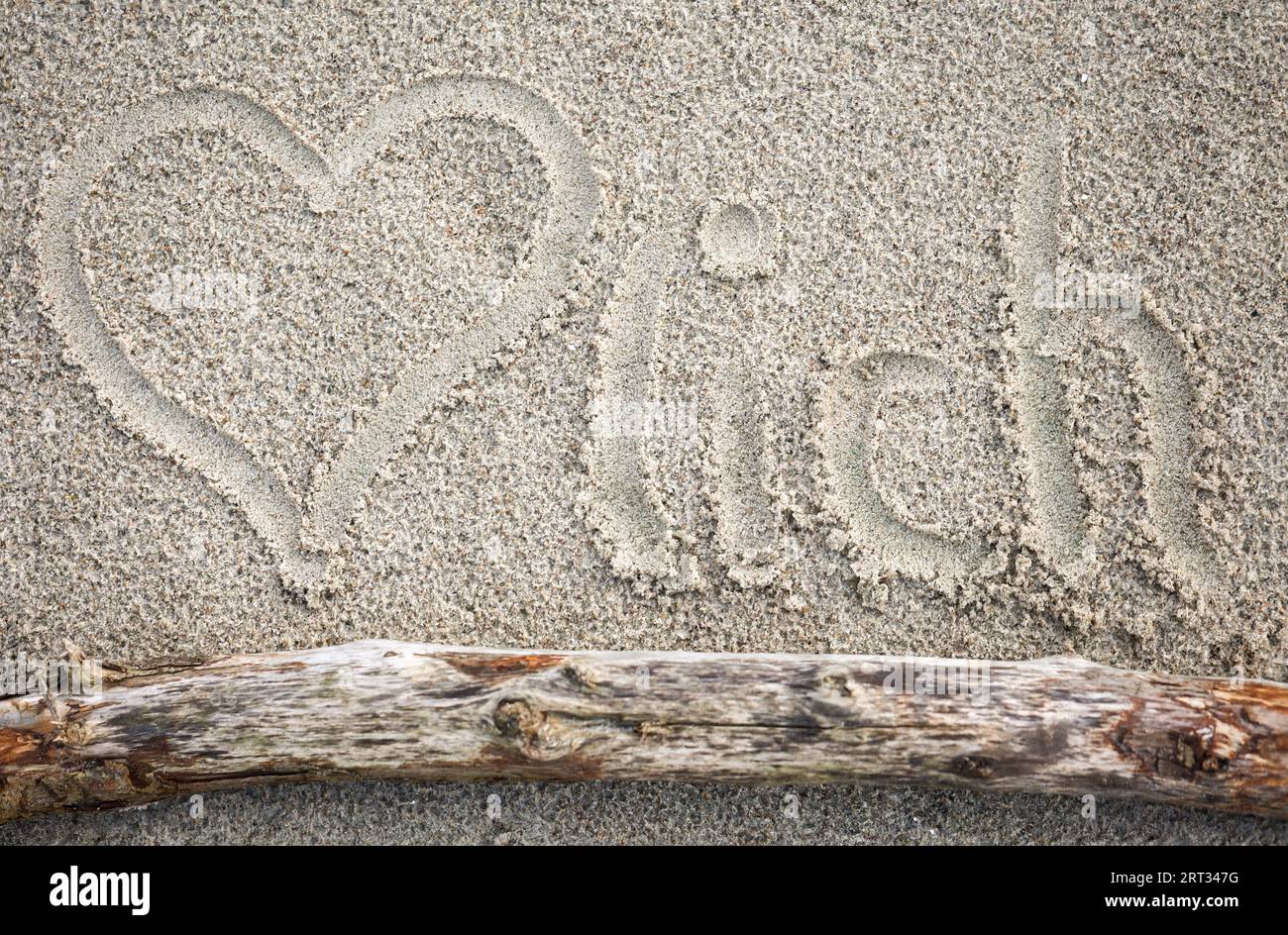 Un cuore trascinato nella sabbia, e la parola cordial Foto Stock