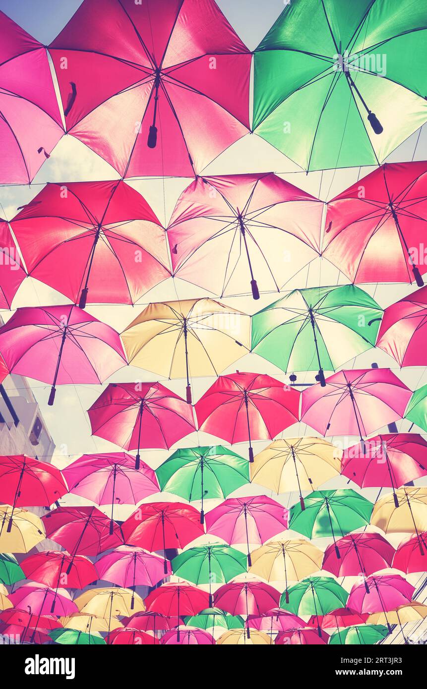 Appendere gli ombrelli colorati contro il cielo, viene applicato un tono di colore. Foto Stock
