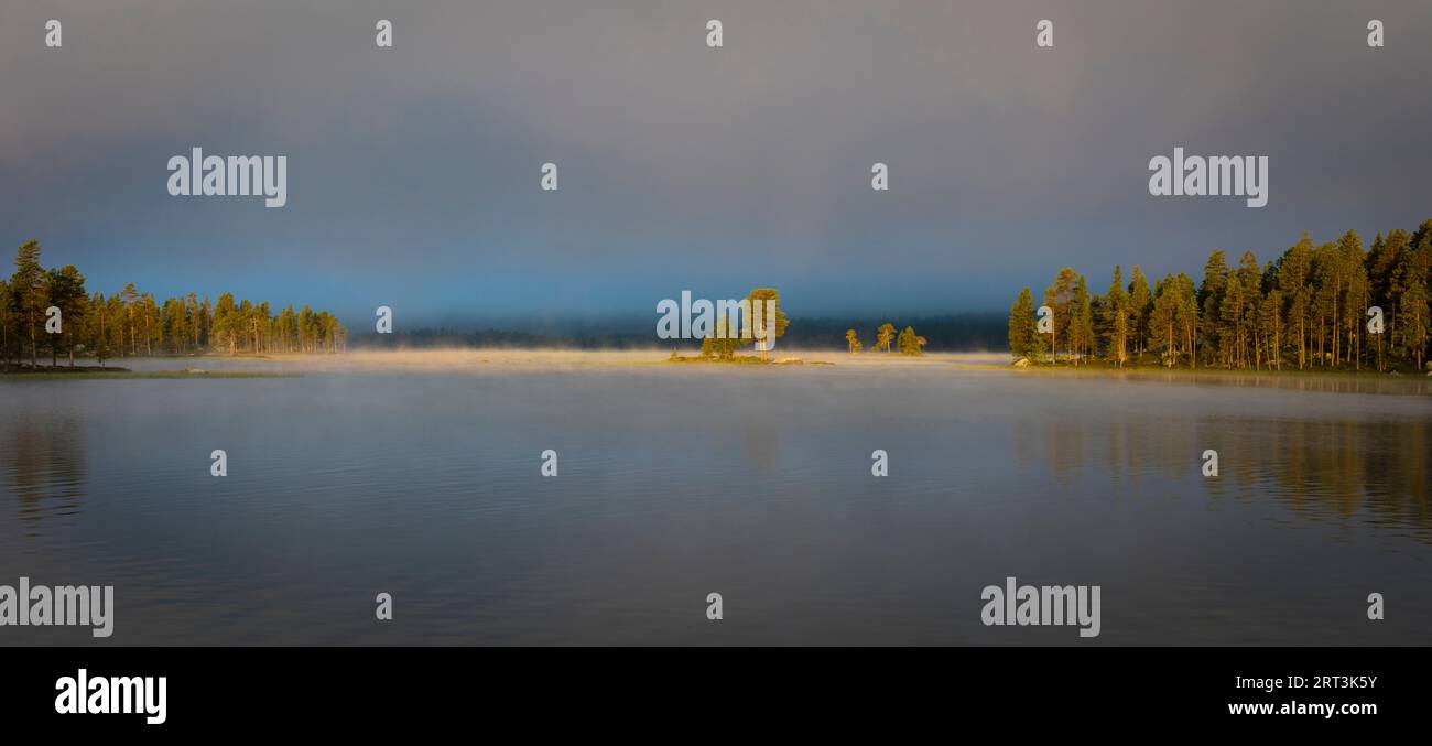 Vista panoramica del nebbioso paesaggio mattutino autunnale sul lago Isteren a Engerdal kommune, Norvegia, Scandinavia. Foto Stock