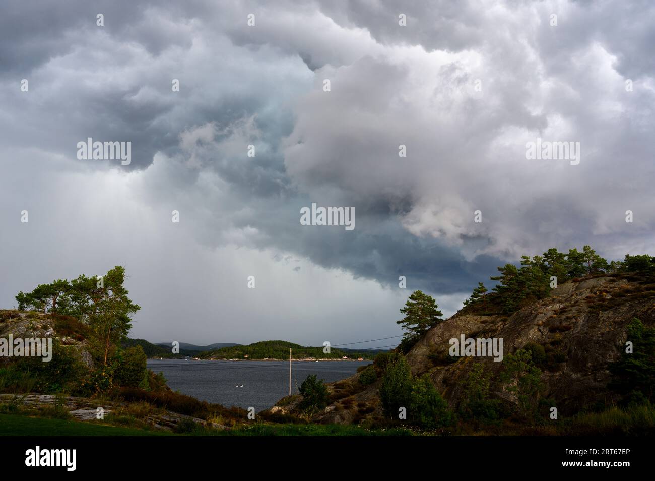 Spettacolari nubi di tempesta che si accumulano sopra la riva e si muovono verso le isole dell'arcipelago di Kragero una giornata estiva in agosto. Telemark, Norvegia. Foto Stock