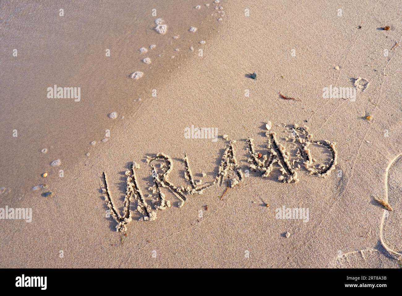 Parola di vacanza nella sabbia della spiaggia Foto Stock
