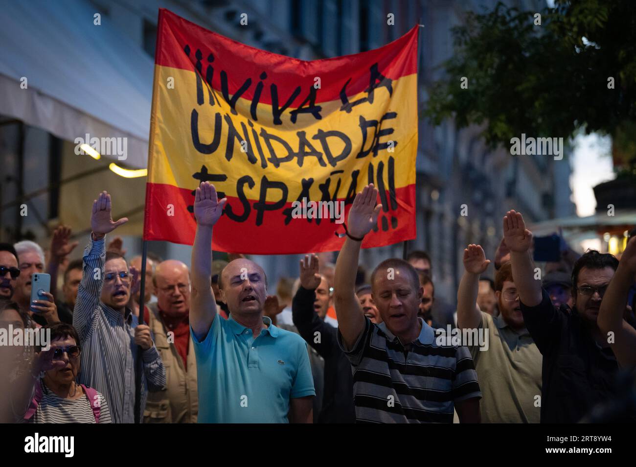 Madrid, Spagna. 11 settembre 2023. I manifestanti che alzano le mani salutano i nazisti portando con sé una bandiera spagnola con le parole "lunga vita all'unità di Spagna" si vedono durante una protesta del partito di estrema destra "Falange Española de las JONS". Il partito di estrema destra chiede il divieto dei partiti politici e delle associazioni che promuovono il separatismo, durante una protesta che coincide con la giornata nazionale catalana, nota anche come "Diada”. Crediti: Marcos del Mazo/Alamy Live News Foto Stock