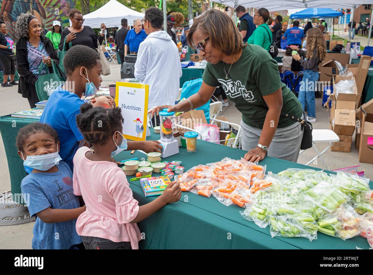 Detroit, Michigan - i bambini imparano a preparare frullati sani con un frullatore finto e frutta durante una festa di blocco salute organizzata dal dEtr Foto Stock