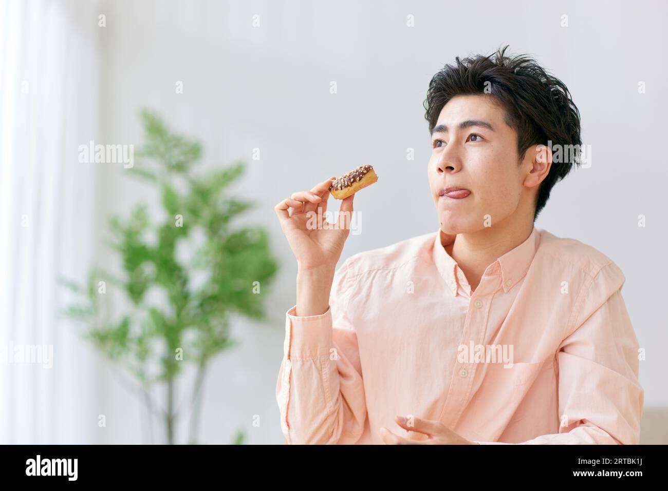 Uomo giapponese che mangia a casa Foto Stock