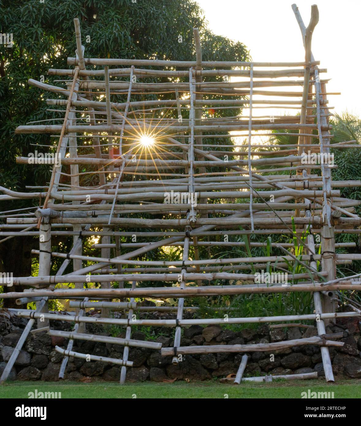 Primo piano del quadro di un tradizionale legno, struttura a palo, hale hawaiano, con scoppio di sole, lungo la strada per Hana, percorso panoramico Foto Stock