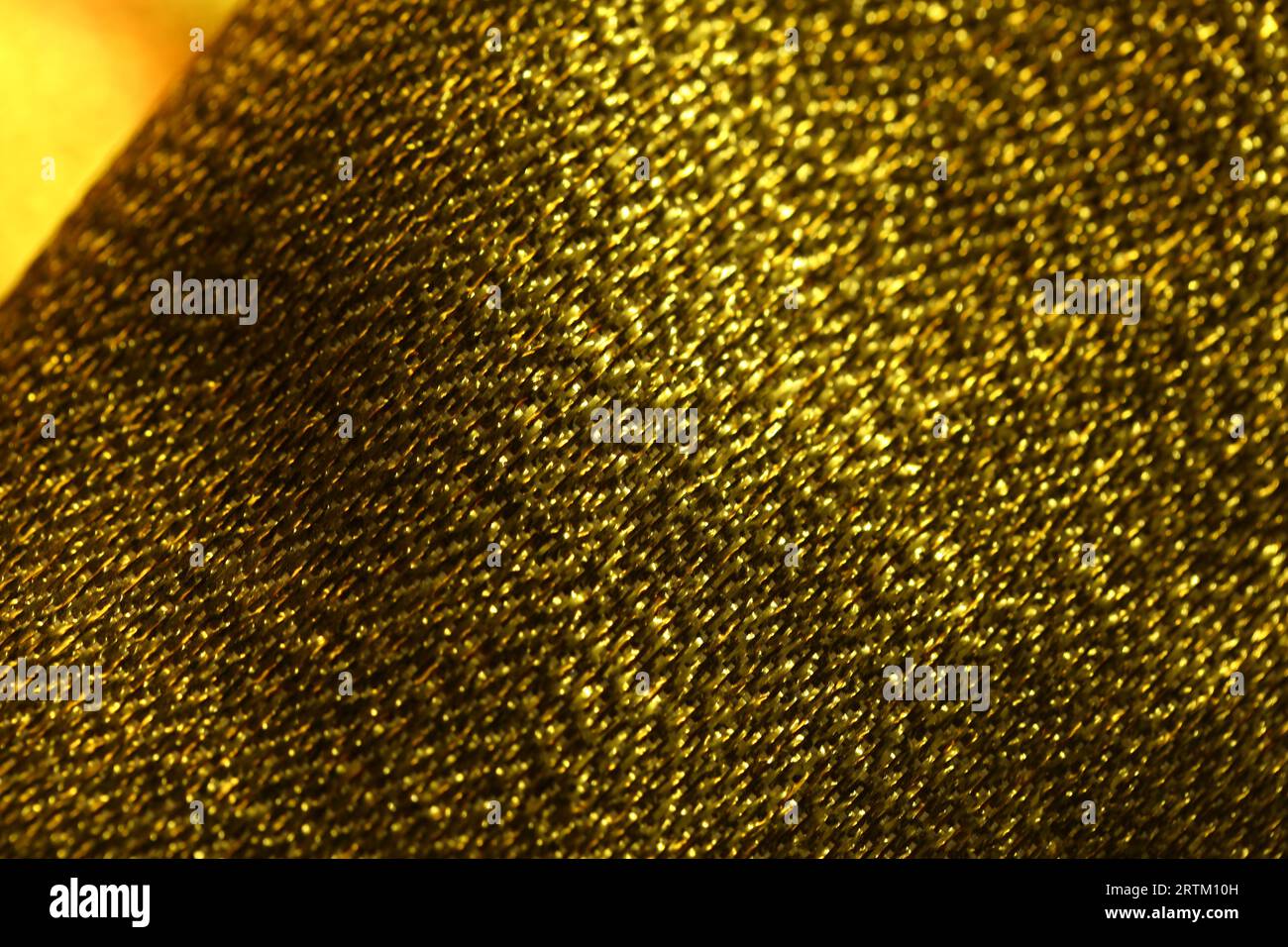 Foto macro con trama in tessuto oro astratto Foto Stock