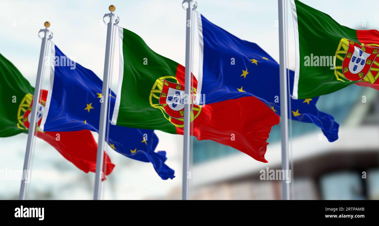 Bandiere del Portogallo che sventolano con bandiere dell'Unione europea in una giornata limpida. Democrazia e politica. Tessuto ondulato, rendering di illustrazioni 3D. Messa a fuoco selettiva Foto Stock