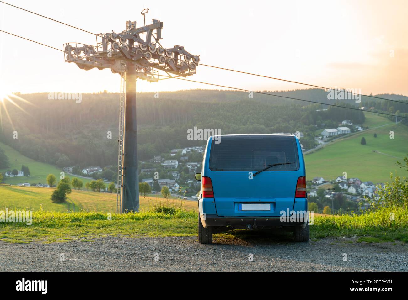 Vanlife. Il pulmino è parcheggiato con la parte posteriore visibile di fronte a una splendida vista di Willingen Upland in Germania. Accanto al veicolo c'è uno skilift. Atmos Foto Stock