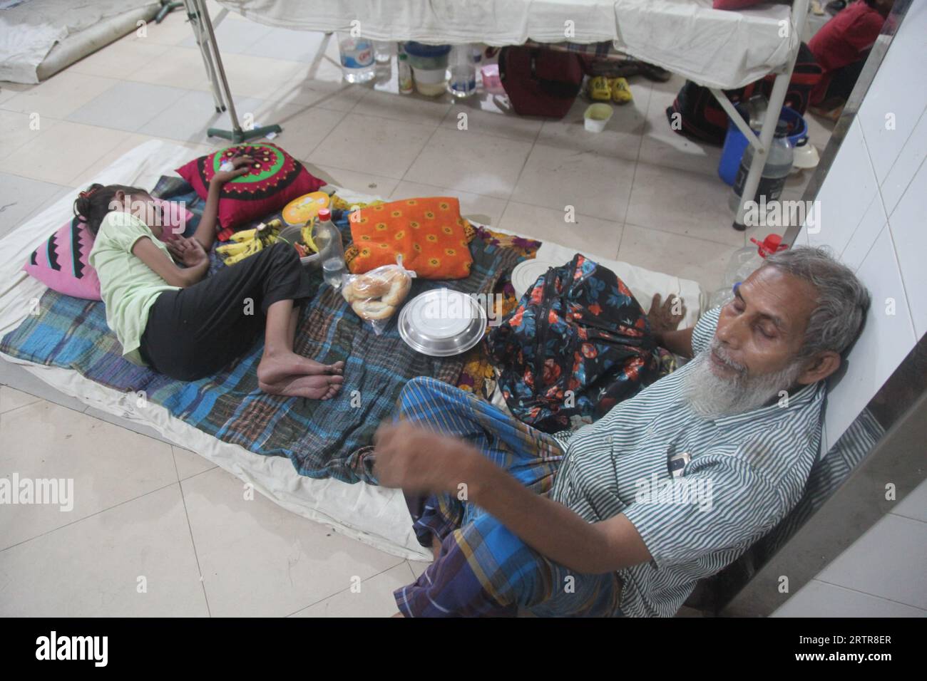 Dacca Bangladesh 14 settembre 2023. Il padre è seduto con preoccupazione accanto alla sua ragazza colpita da dengue. Questa foto è stata scattata Mugda Medical College H Foto Stock