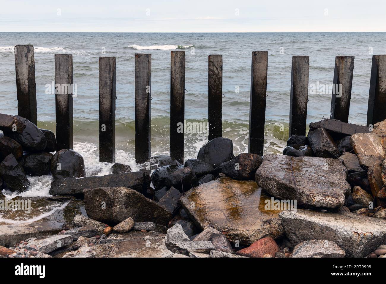 Pilastri e pietre di cemento come parti di un frangiflutti rotto sulla costa del Mar Baltico, Svetlogorsk, Oblast di Kaliningrad, Russia Foto Stock