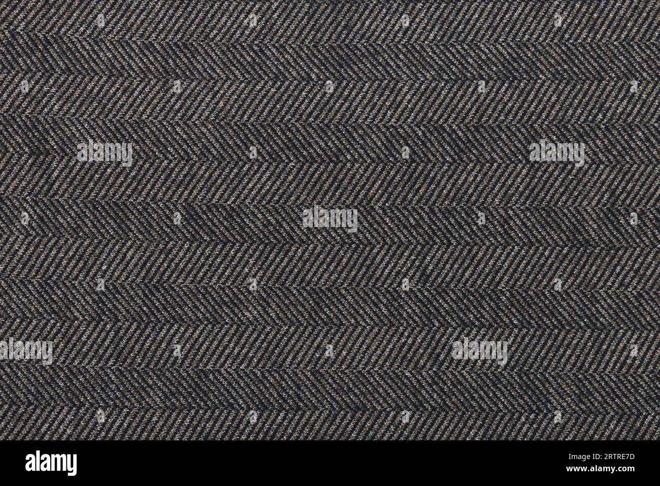 Texture classica in tweed, sfondo in lana. Applicare un primo piano. Tessuto di lana marrone a righe zigzag. Tweed a spina di pesce, texture sfondo in lana. Applicare un primo piano. Foto Stock