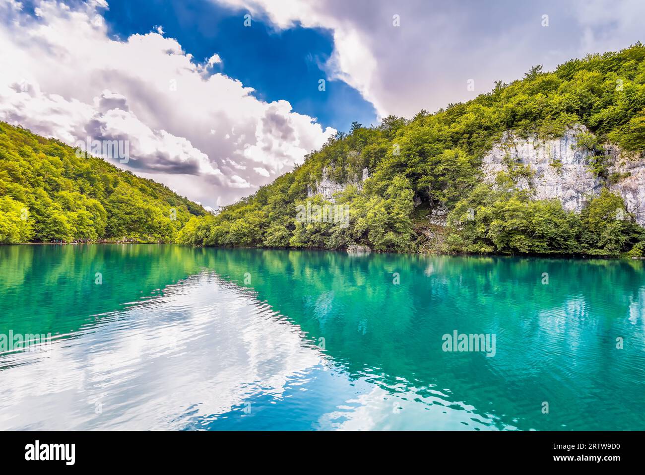 Vista panoramica delle montagne con gli alberi che riflettono le acque turchesi del Parco Nazionale dei Laghi di Plitvice in Croazia Foto Stock