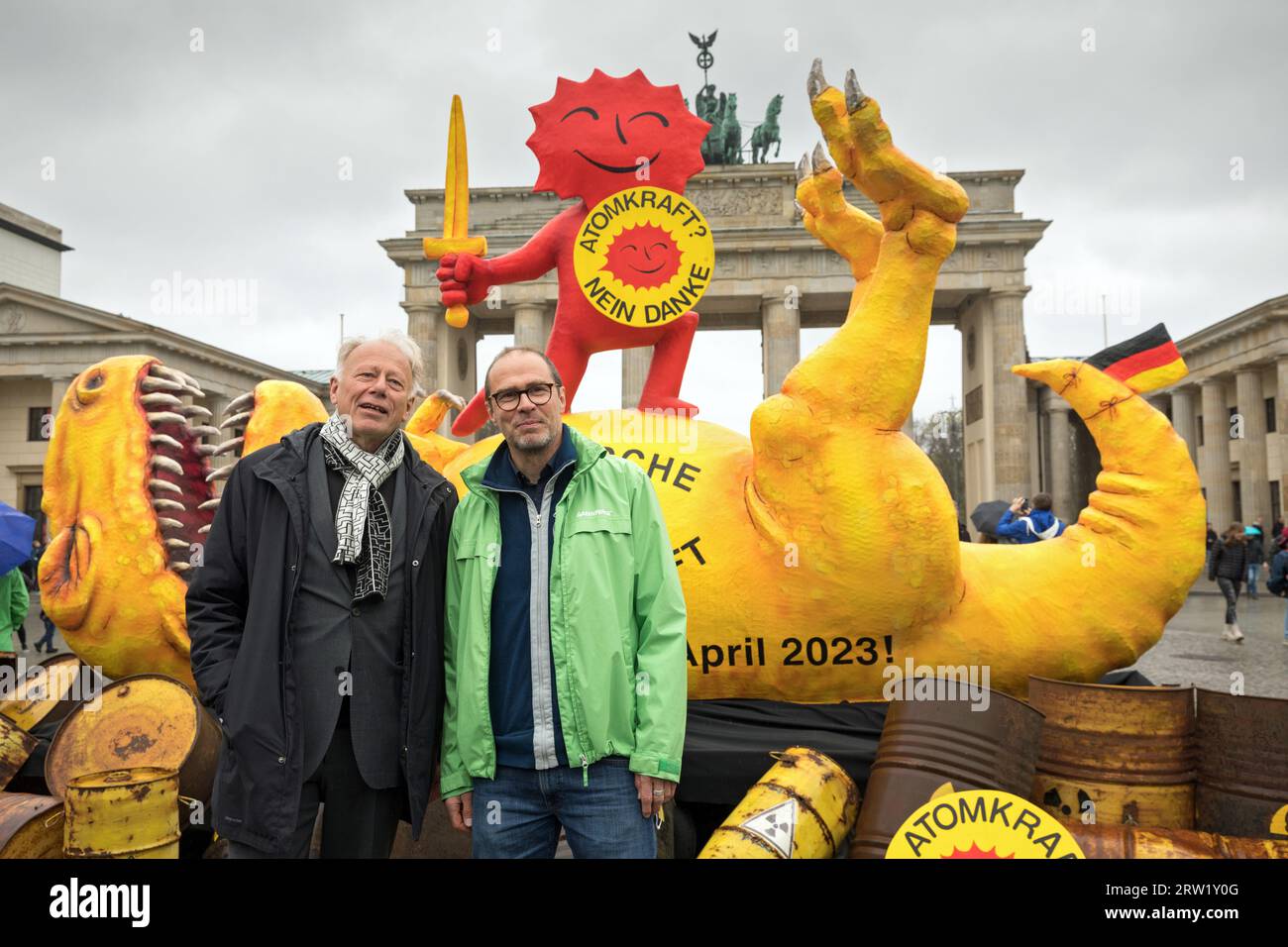 15.04.2023, Germania, Berlino, Berlino - Greenpeace NPP dinosauro scultura alla porta di Brandeburgo. La scultura di dinosauro alta quattro metri, progettata e. Foto Stock