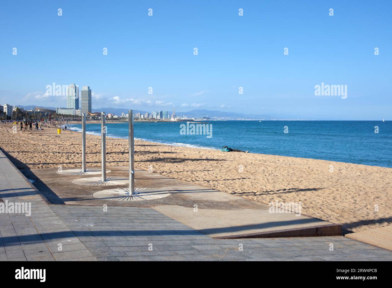 Spiaggia di Barceloneta sul Mar Mediterraneo con docce in una giornata di sole a Barcellona, Catalogna, Spagna Foto Stock