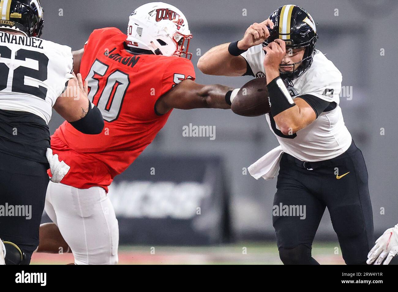 Las Vegas, Nevada, USA. 16 settembre 2023. Il quarterback dei Vanderbilt Commodores Ken Seals (8) ha la palla buttata via dal defensive lineman degli UNLV Rebels Jalen Dixon (50) durante la seconda metà della partita di football del college con i Vanderbilt Commodores e gli UNLV Rebels all'Allegiant Stadium di Las Vegas, Nevada. Christopher Trim/CSM/Alamy Live News Foto Stock