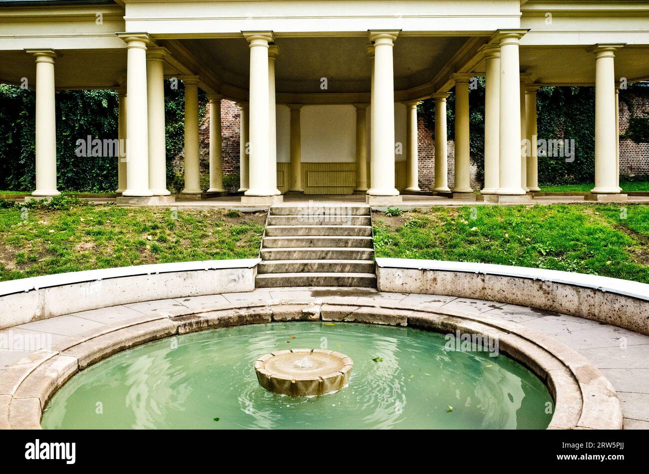 spa dall'architettura classica con colonne e una piscina centrale per il relax Foto Stock