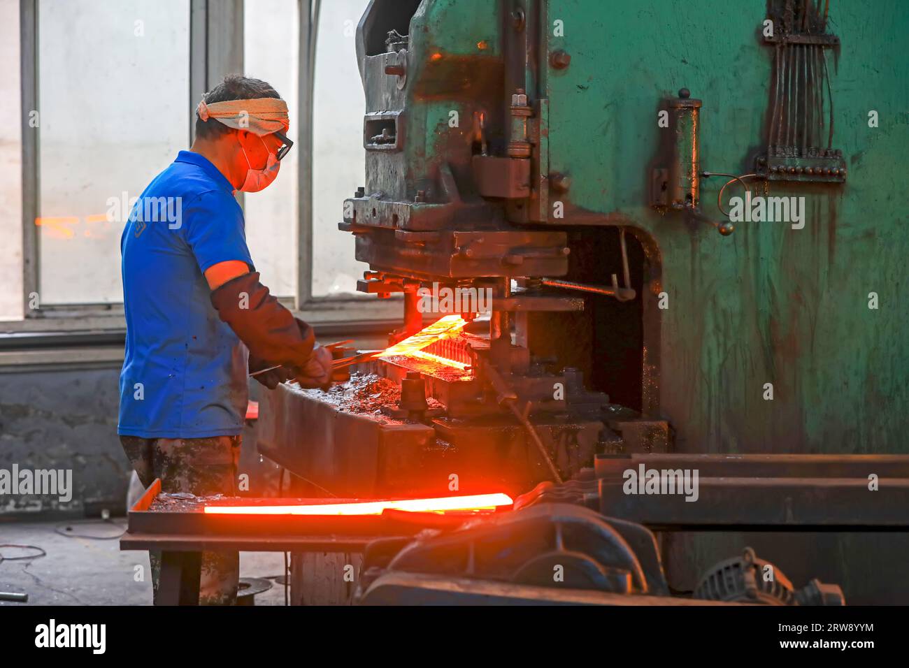 CONTEA DI LUANNAN, Cina - 24 settembre 2021: I lavoratori lavorano intensamente su una linea di produzione di forgiatura in uno stabilimento di produzione di utensili hardware nel nord della Cina Foto Stock