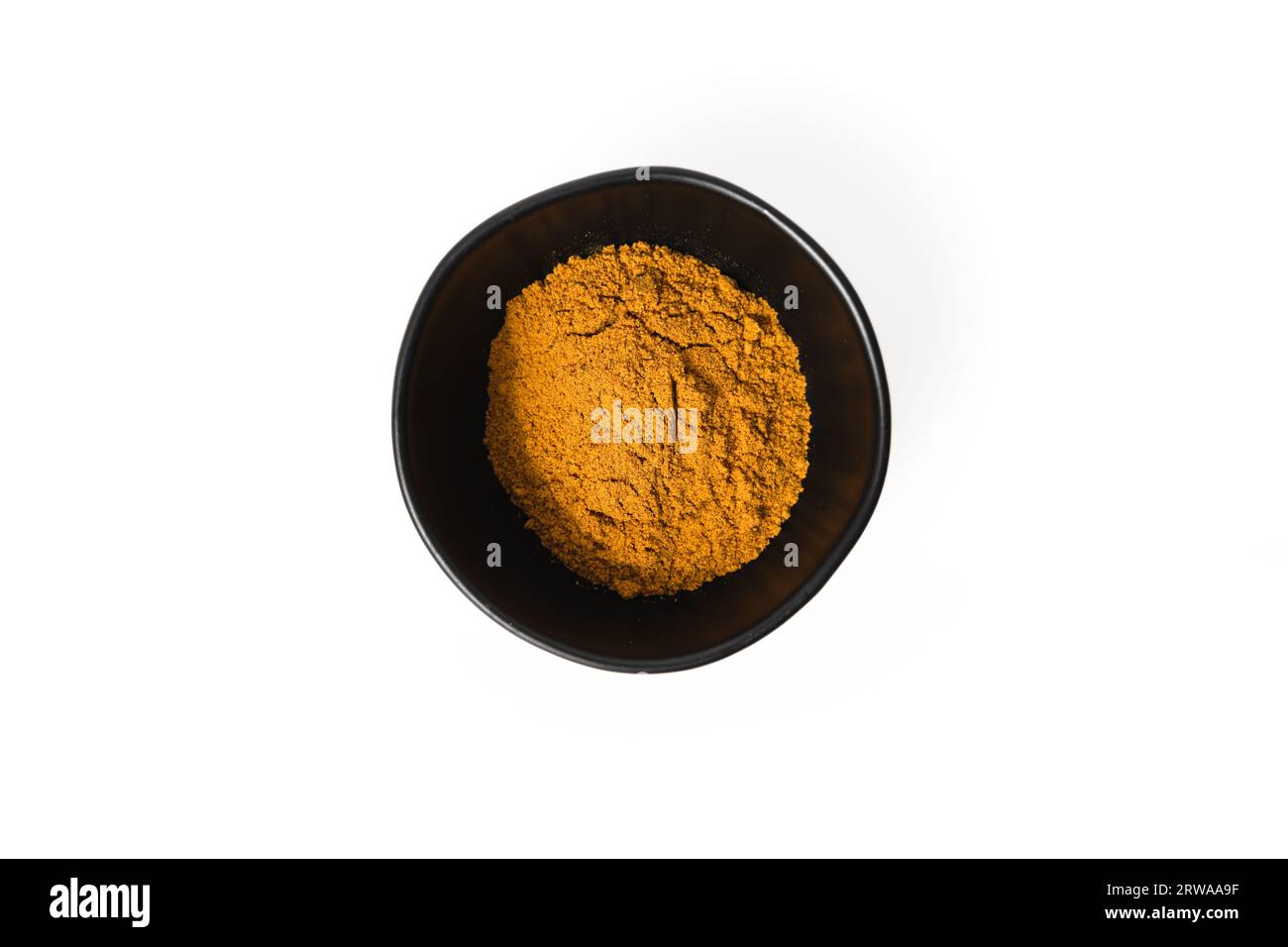 Un recipiente arancione brillante di semi di rosa in polvere per un prodotto per la cura della pelle Foto Stock