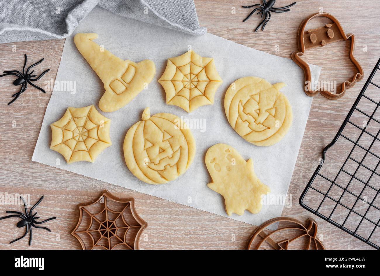 Preparazione di biscotti per le feste da cuocere in forno. Biscotti di Halloween pronti da cuocere a forma di zucche e fantasmi Foto Stock