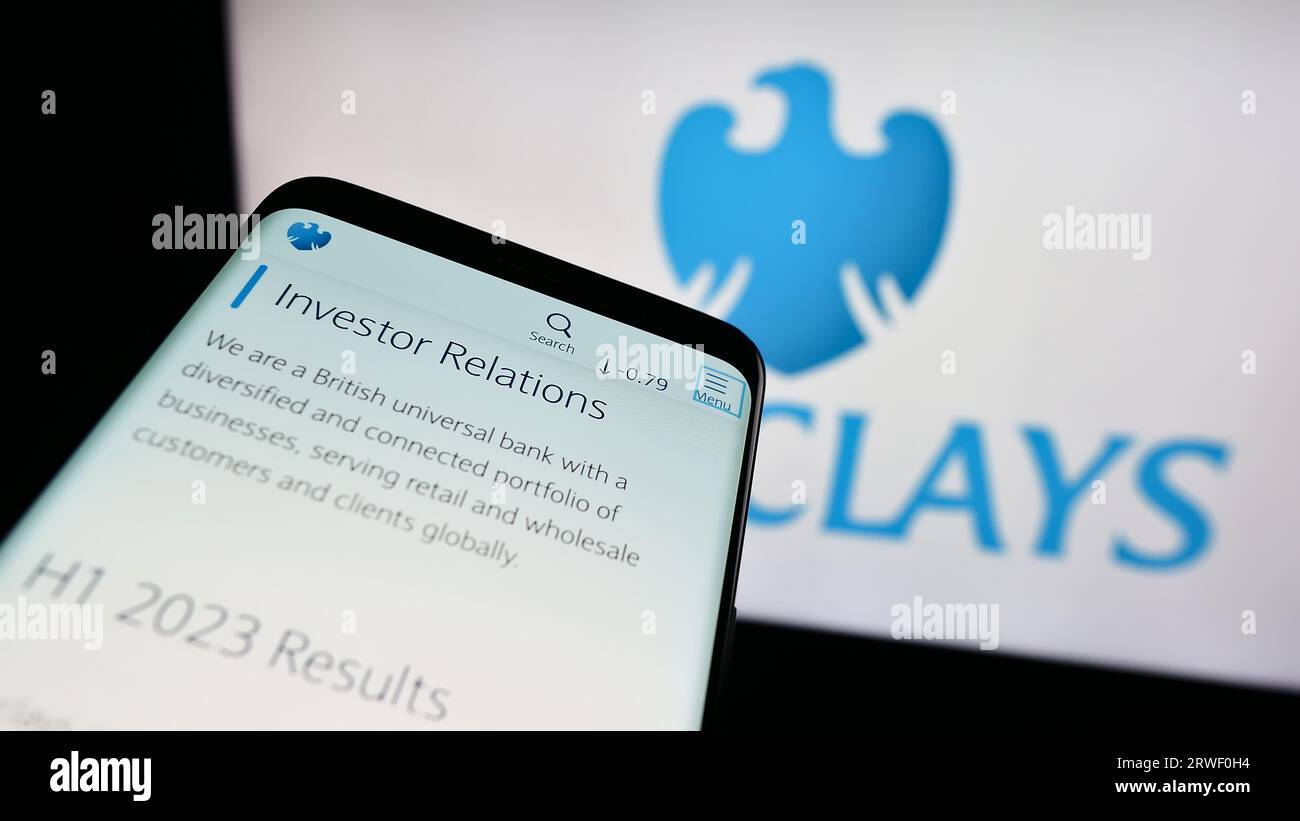 Telefono cellulare con sito Web della banca universale britannica Barclays plc sullo schermo davanti al logo aziendale. Mettere a fuoco in alto a sinistra sul display del telefono. Foto Stock