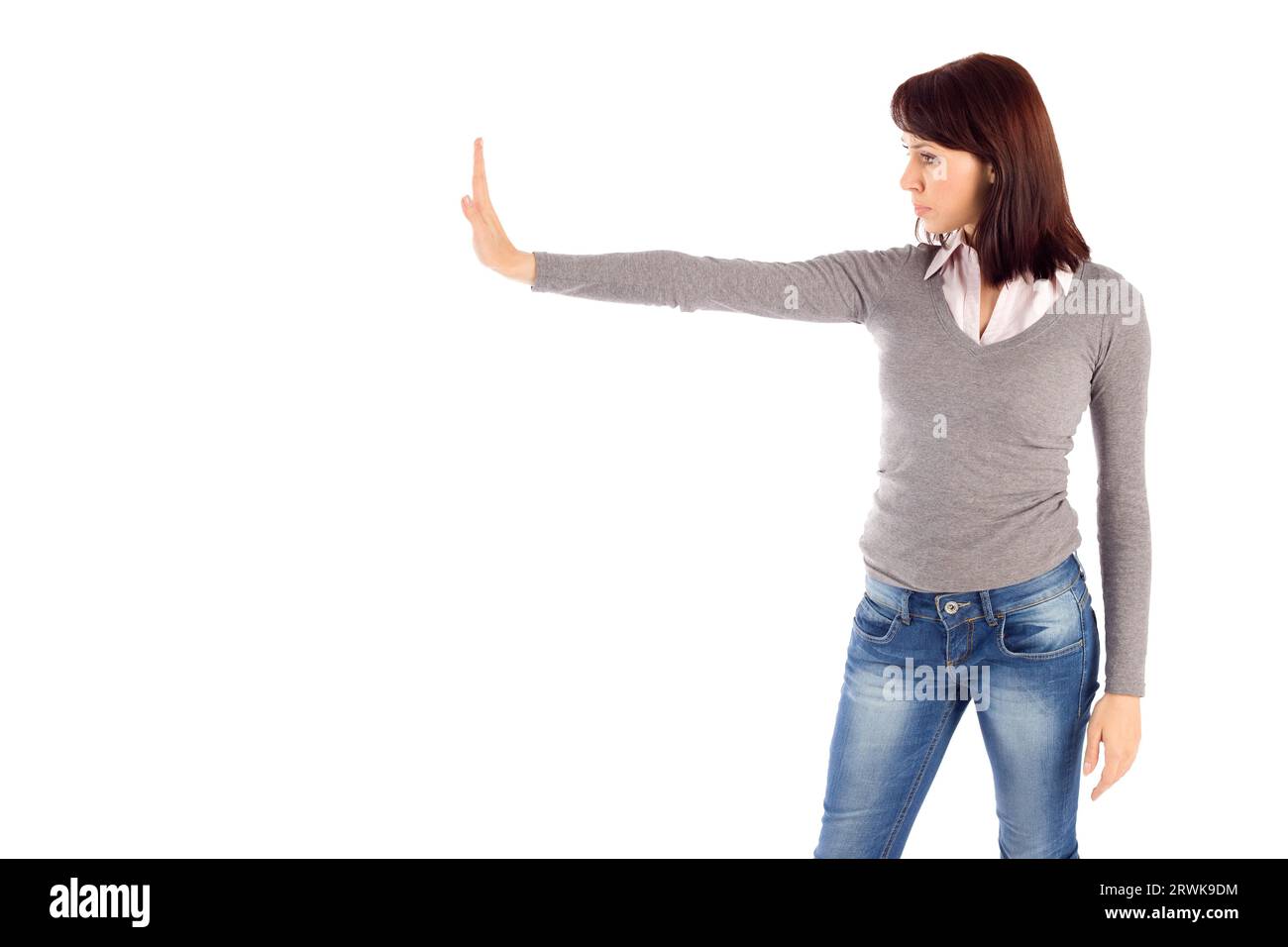 Giovane donna attraente che mostra il gesto di arresto, isolato su sfondo bianco Foto Stock