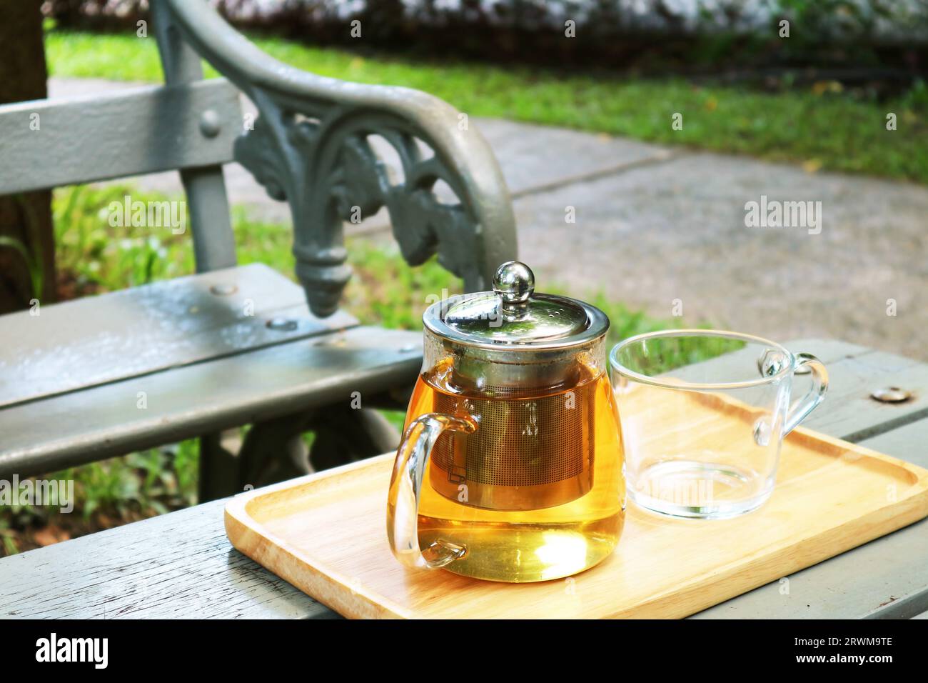 Primo piano del piatto di tè caldo con una tazza sul tavolo da giardino Foto Stock