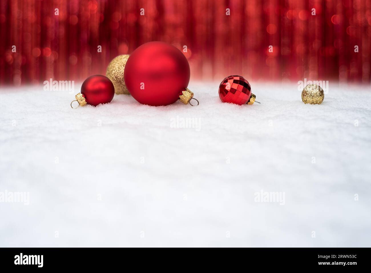 Festeggiamenti di Natale con le balli di Natale rosse sulla neve Foto Stock