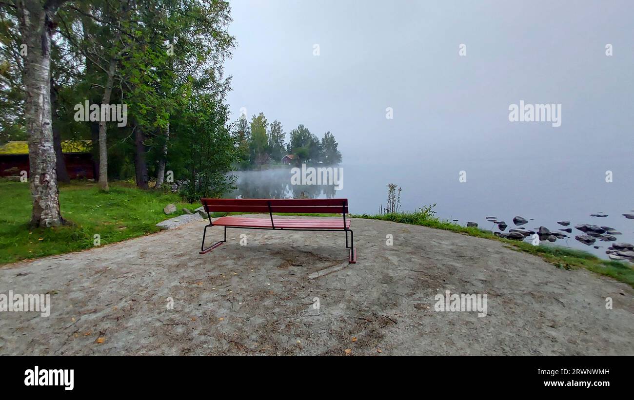 Quando la nebbia mattutina cerca di sollevarsi dal lago, e far uscire il sole. Foto Stock