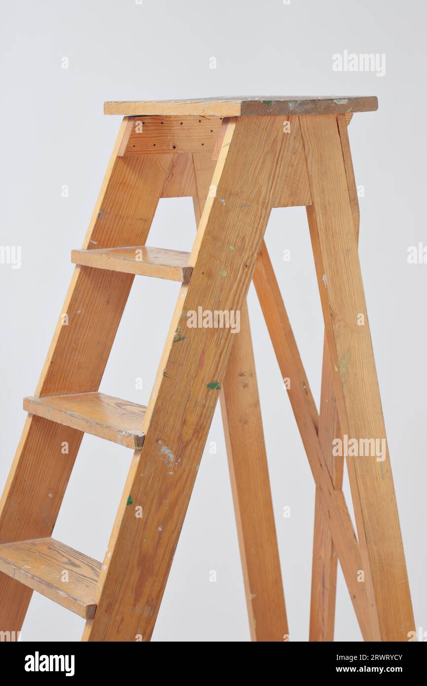 Vecchia scala di legno contro uno sfondo grigio Foto Stock